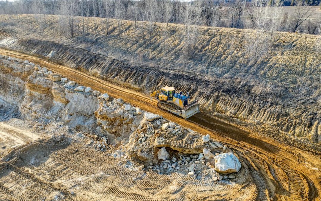 https://www.pexels.com/photo/yellow-bulldozer-working-on-coal-mine-12247603/