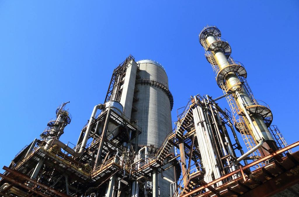 low angle shot of manufacturing plant under blue sky